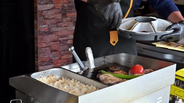 Street Food Chef Cooking Meat And Vegetables On A Griddle In An Open Air Mobile Kitchen