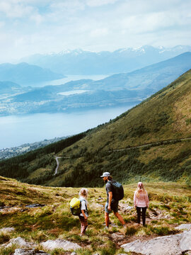 Family hiking in Norway travel lifestyle summer vacations together parents and child outdoor - father, mother and kid explore mountain trails in Sunnmore Alps, active people freedom