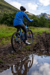 Fototapeta premium Cyclists exploring muddy mountain trails.