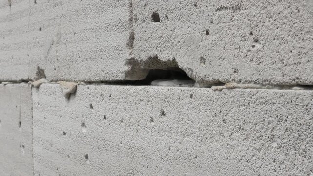 a hole in a light brick wall