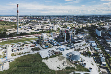 Obraz premium Ravenna, Italy, June 8, 2026: Aerial view of the industrial and port area, featuring storage tanks, power plants, steel manufacturing sites, and logistics infrastructure