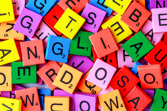 Alphabet letters on wooden block pieces, from above.Close up of Wooden letter cubes.Challenge and solution concept.Hobbies and leisure activities