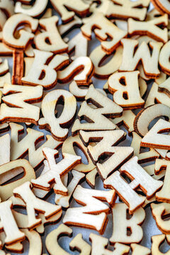 Alphabet letters on wooden block pieces, from above.Close up of Wooden letter cubes.Challenge and solution concept.Hobbies and leisure activities