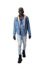 Fototapeta premium Portrait of a young man in street clothes from front view walking on a white background.