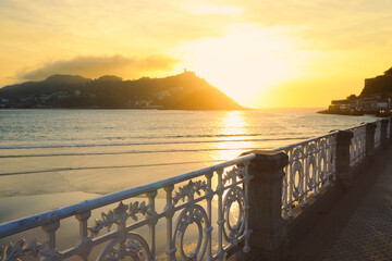 Selective focus on fence, Beautiful sunset over the sea in San Sebastian, Spain © nonglak