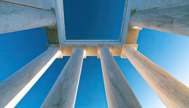 Majestic marble pillars rise towards a clear blue sky, framing a geometric opening