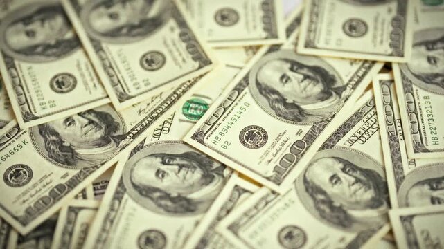 A smooth top-down sweep over a spread of vintage dollar bills highlights a paper-money concept, providing a financial backdrop for business and advertising visuals, emphasizing economic themes