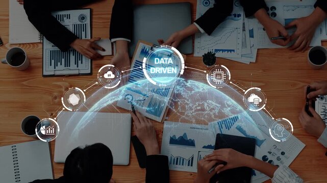 A business team engages in collaboration around data driven insights for strategic planning in a modern office, showcasing global connectivity and innovation. Raster