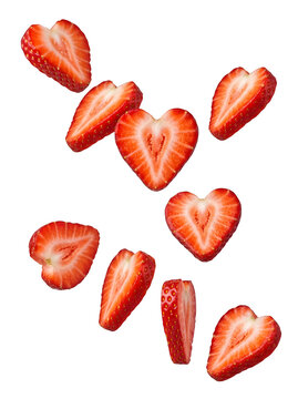 Fresh strawberry slices shaped like hearts falling isolated on transparent background