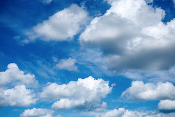 Fototapeta premium White clouds across vivid blue sky, concept of weather background, clean copy space and natural summer atmosphere.
