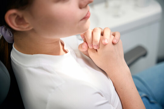 Young woman in clinical setting, feeling apprehensive indoors