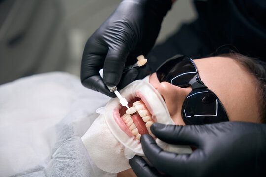 Adult undergoing dental procedure in clinic during daytime