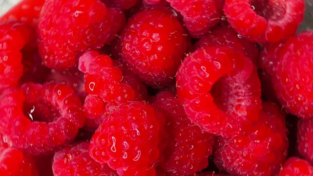 Raspberries rotating background top view. Fresh and ripe organic Diet, dieting, healthy vegan food. Organic Blue berries, macro shot. Vegan sweet food, flat lay