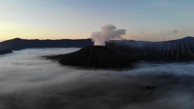 Drone Hovering Above Active Mount Bromo Crater Panning Across Volcanic Smoke Plume, Java, Indonesia