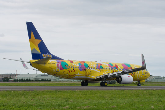 Ibaraki Airport, Japan - June 11, 2022: Skymark Airlines B737-800 (JA73AB) "Pikachu Jet BC1" rear three-quarter view showing blue star tail, winglet sakura decoration  with full fuselage Pikachu art