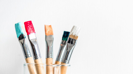 Fototapeta premium Colorful brushes in glass jar
