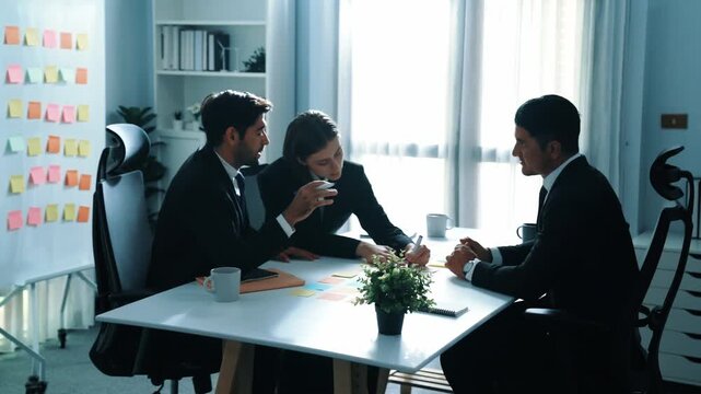 Smart businessman join meeting while marketing team talking plan at table with colorful sticky notes. Group business people brainstorming financial strategy while sitting at meeting room. Directorate.