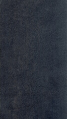 Fototapeta premium Dark gray textured mobile wallpaper with a subtle, rough surface and matte finish