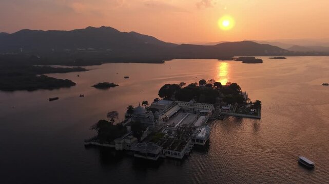 Sunset Drone View of Jag Mandir Island Palace Udaipur on Lake Pichola Featuring Golden Hour Sky, Royal Architecture, and Scenic Rajasthan Heritage Landscape
