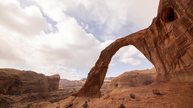 Time Lapse the clouds moving behind the amazing Corona Arch near Moab, Utah, USA.