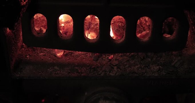 Fire heating furnace flames behind screen door