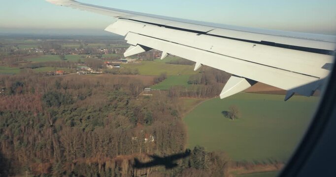 Airplane landing view of aircraft shadow on the ground