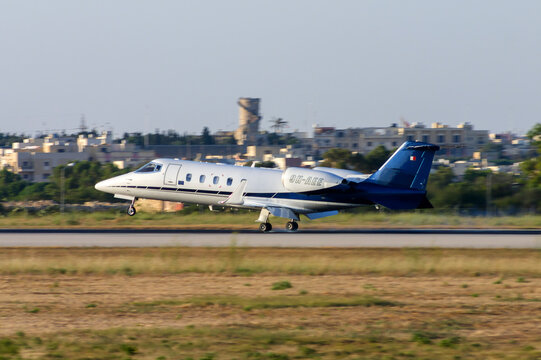 Luqa, Malta - June 29, 2005: Eurojet Learjet 60 (Reg: 9H-AEE) landing runway 32 in the late evening summer sun.
