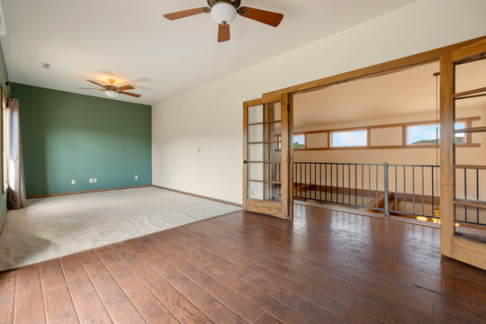 Spacious split-level living room with wood floors