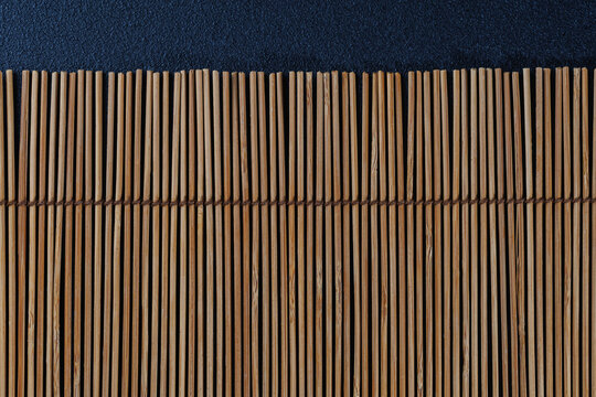 Vertical bamboo reed mat with dark blue minimal background, stylish Asian texture for luxury food branding, spa wellness visuals and elegant menu templates