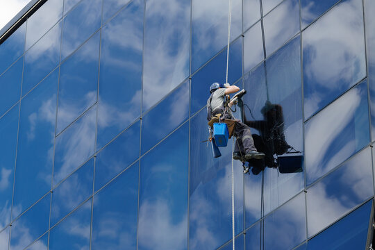Industrial climber cleaning glass facade