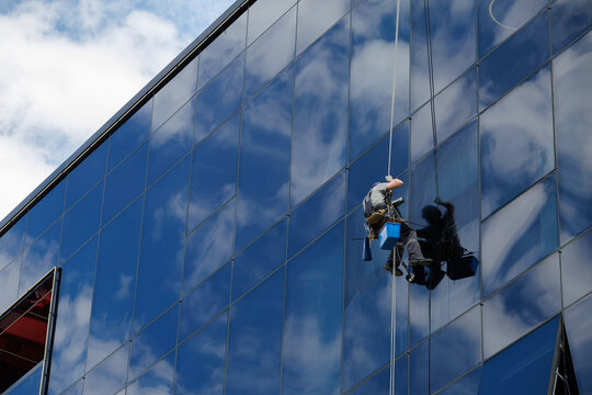 Industrial climber cleaning glass facade