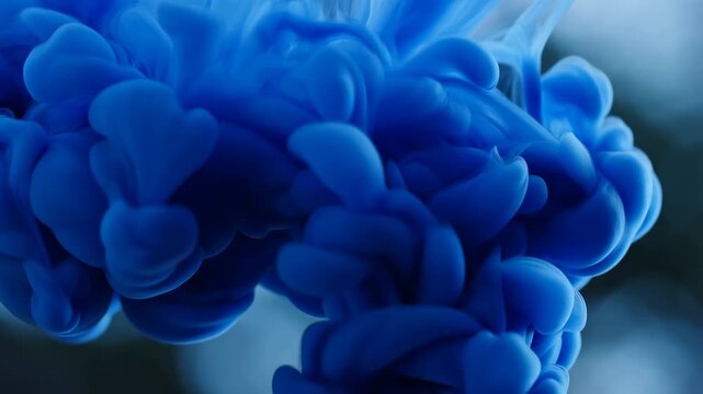 Blue ink cloud expanding in water  captivating fluid motion in slow motion