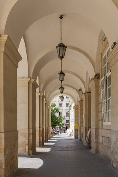 Historic stone archway arcade of Lviv City Hall with vintage lanterns