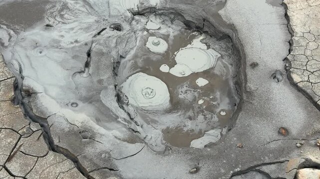 Bubbling mud pool in the Hverir geothermal area near Lake Myvatn, Iceland. Hydrogen sulfide fumaroles creating boiling mudpots on the ground