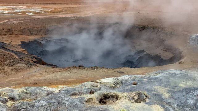 Incredible volcanic landscape of the Hverir geothermal area in Iceland. Hot steam rising from a fumarole with sulfur deposits on the ground