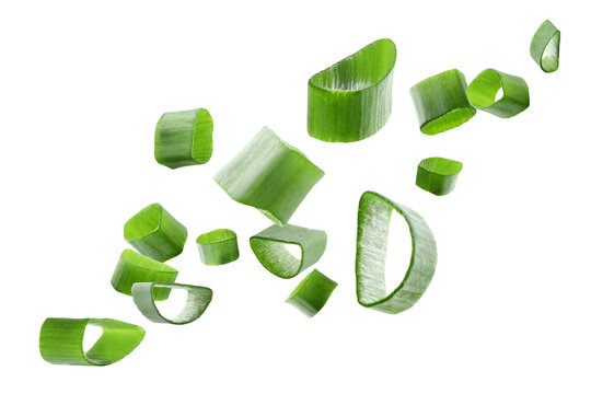 Cut green onion flying in air on transparent background