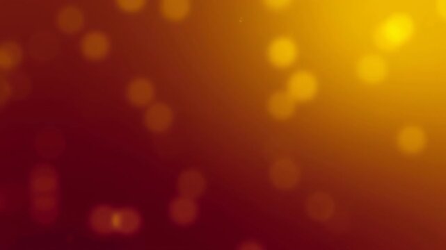 Abstract warm golden bokeh lights drifting on red background