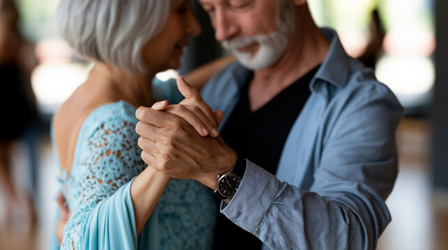 Anonymous active elderly couple attending a tango dance lesson, social dancing and lifelong learning concept, faceless, defocused dance studio background, with copy space