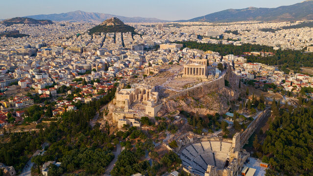 Acropolis of athens standing proudly above the sprawling city. Showcasing timeless ancient architecture with the iconic parthenon and the odeon of herodes atticus. Symbols of greek history and culture