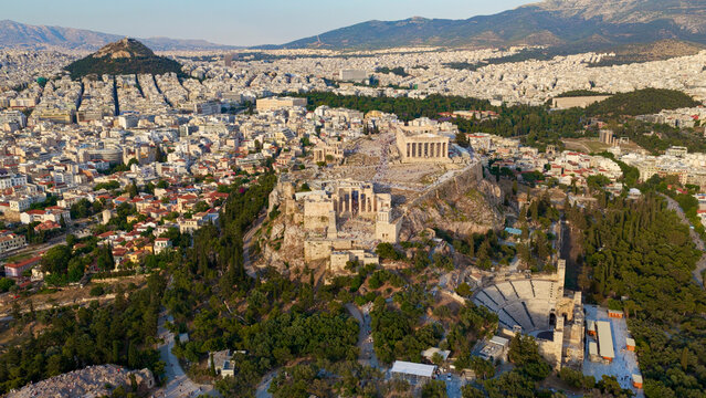 Acropolis complex featuring the parthenon and odeon of herodes atticus offering an aerial cityscape view of athens, greece, showcasing ancient global history and travel destinations during daylight
