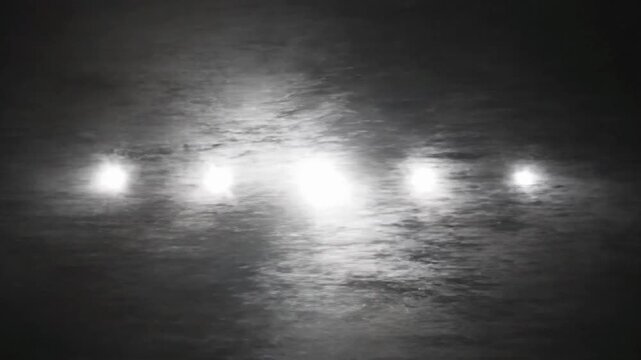 Bright flashing white light creates strobe effect in dark environment during nighttime