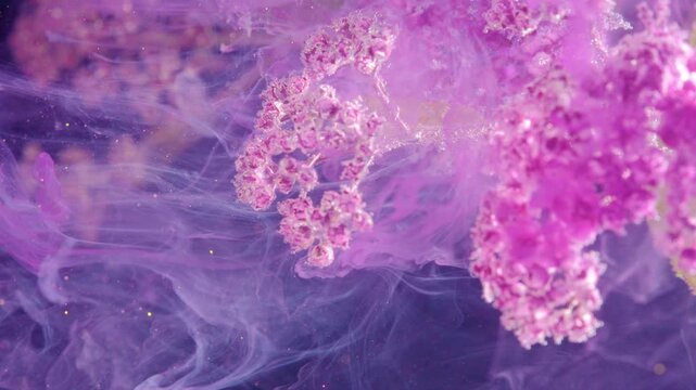 Delicate pink flower clusters glow in the upper right while soft purple mist swirls across a dark abstract backdrop, creating an elegant and dreamy floral scene