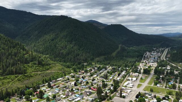 Aerial view showing the small town of Osburn Idaho nestled among dense forests and Saint Joe mountains in spring