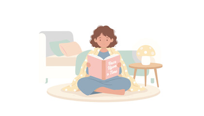 Fototapeta premium A girl reads a pink book titled Once Upon a Time while sitting cross-legged on a round rug wrapped in a soft star patterned blanket.