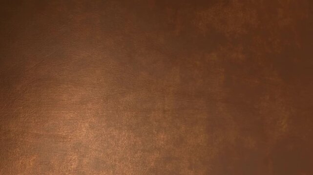 Slow pan tracking shot of textured brown leather surface revealing subtle light reflection on studio backdrop interior tabletop set