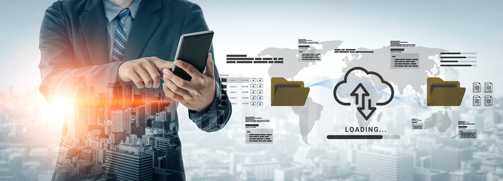 A businessman interacts with a digital tablet while cloud computing visuals with loading graphic appear against a vibrant urban cityscape, symbolizing modern technology and data management. Ledger