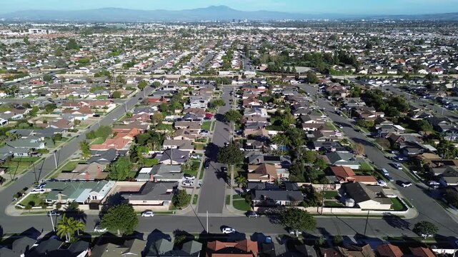 Homes near Martin Ave Bushard St form tight residential grid in west Fountain Valley, Orange County. Varied roof tones, trimmed lawns, soft midday contrast shape calm suburban pattern in CA