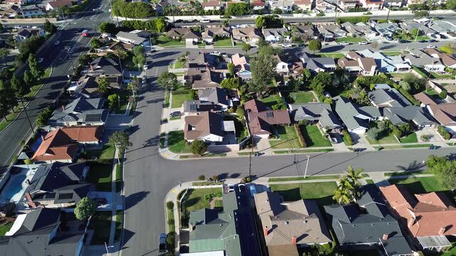 Neighborhood between Talbert Ave La Zanja St displays uniform lots, intersecting streets within west Fountain Valley, Orange County, CA. Warm roof colors, balanced shadows mark aerial perspective