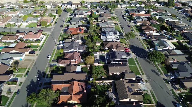 Parallel residential lanes near Bushard St Talbert Ave show looping streets, compact parcels across west Fountain Valley, Orange County. Mixed rooflines, clipped lawns, soft overhead contrast, CA