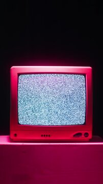 Retro TV, vintage television In a nostalgic setup, a retro TV displays grain on screen, scary halloween night device good for chroma key and green screen